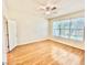 Bright bedroom featuring wood floors and a large window offering ample natural light at 13648 Crest Lake Dr, Hudson, FL 34669