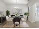 Bright dining room with modern chandelier and glass dining table set at 14604 Strathglass Dr, Hudson, FL 34667