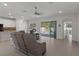 Open floor plan with a view of the pool, featuring tile floors and a modern ceiling fan at 14604 Strathglass Dr, Hudson, FL 34667