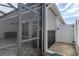 Covered patio area with easy access to the fenced-in yard provides an ideal space for outdoor relaxation and entertainment at 14604 Strathglass Dr, Hudson, FL 34667