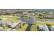 Aerial view of homes in community with golf course, waterfront, and lush landscaping at 1809 Westerham Loop, Trinity, FL 34655