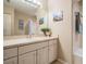 Bathroom with white cabinets, updated mirror, shower and vanity area at 1809 Westerham Loop, Trinity, FL 34655