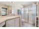 Bathroom featuring a modern glass shower, a white vanity, and tile flooring at 1809 Westerham Loop, Trinity, FL 34655