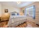Bedroom with hardwood floors, a comfortable bed, and a bright window at 1809 Westerham Loop, Trinity, FL 34655