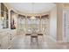 Cozy dining area with a glass-top table set next to a bright window at 1809 Westerham Loop, Trinity, FL 34655