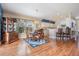 Open-concept dining area with hardwood floors, a chandelier, and a view into the kitchen and living areas at 1809 Westerham Loop, Trinity, FL 34655