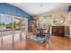 Elegant dining room featuring wood floors, a chandelier, and a view of the lake through sliding glass doors at 1809 Westerham Loop, Trinity, FL 34655