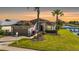 Charming single-story home with a two-car garage, a manicured lawn, and waterfront access at 1809 Westerham Loop, Trinity, FL 34655