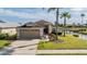 Charming home featuring a well-manicured lawn, a two-car garage, and waterfront view at 1809 Westerham Loop, Trinity, FL 34655