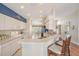 Kitchen featuring white cabinets, updated appliances, and breakfast bar with seating at 1809 Westerham Loop, Trinity, FL 34655