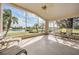 Relaxing sunroom featuring large windows, waterfront views, and comfortable seating at 1809 Westerham Loop, Trinity, FL 34655