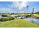 Scenic waterfront view with a charming bridge and meticulously maintained landscaping at 1809 Westerham Loop, Trinity, FL 34655
