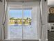 Backyard view through sliding glass doors highlights outdoor patio and spacious fenced yard at 1811 Harbour Blue St, Ruskin, FL 33570