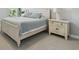 Bedroom with an off white wood bed frame and side table at 1811 Harbour Blue St, Ruskin, FL 33570