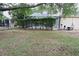 View of the backyard showcasing the screened-in pool with well trimmed hedges surrounding the perimeter at 19109 Beckett Dr, Odessa, FL 33556