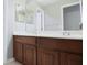 Bathroom vanity with double sinks and dark wood cabinetry at 19109 Beckett Dr, Odessa, FL 33556