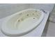Close-up of soaking tub with jets and tile surround at 19109 Beckett Dr, Odessa, FL 33556