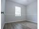 Empty bedroom featuring wood-look floors and neutral paint at 19109 Beckett Dr, Odessa, FL 33556
