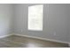 Bright bedroom featuring a window and wood-style flooring at 19109 Beckett Dr, Odessa, FL 33556