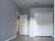 Neutral bedroom with a closet and an adjacent doorway at 19109 Beckett Dr, Odessa, FL 33556