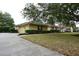 Well-maintained single-Gathering home with lush lawn, mature trees, and a two-car garage at 19109 Beckett Dr, Odessa, FL 33556
