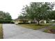 Well-maintained single-Gathering home featuring a manicured lawn, mature tree, and spacious driveway at 19109 Beckett Dr, Odessa, FL 33556