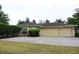 View of the home's exterior featuring a three-car garage and well-maintained landscaping at 19109 Beckett Dr, Odessa, FL 33556