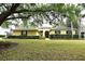 Charming single-story home featuring a lush lawn, arched doorway, and well-maintained landscaping at 19109 Beckett Dr, Odessa, FL 33556