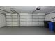 Spacious two-car garage with a clean floor and white doors at 19109 Beckett Dr, Odessa, FL 33556