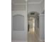 Hallway with tiled flooring, architectural arches, and neutral gray paint at 19109 Beckett Dr, Odessa, FL 33556