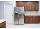 Kitchen featuring a stainless steel refrigerator, wood cabinets, and white countertops at 19109 Beckett Dr, Odessa, FL 33556