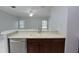 Kitchen with stainless steel dishwasher, faucet, and dark wood cabinetry at 19109 Beckett Dr, Odessa, FL 33556