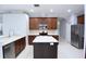 Spacious kitchen featuring stainless steel appliances, a central island and abundant cabinet space at 19109 Beckett Dr, Odessa, FL 33556
