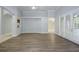 Open-concept living room with stylish floors and sliding glass doors to outside at 19109 Beckett Dr, Odessa, FL 33556