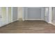 Open-concept living room with stylish floors and sliding glass doors to outside at 19109 Beckett Dr, Odessa, FL 33556