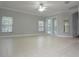 Open living room with tiled floors, recessed lighting, and double doors, creating a bright and spacious area at 19109 Beckett Dr, Odessa, FL 33556