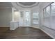 Bright living room with wood floors, large windows, and french doors to outdoor patio at 19109 Beckett Dr, Odessa, FL 33556