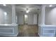 Living room with wood floors, decorative pillars, and doorways to other rooms at 19109 Beckett Dr, Odessa, FL 33556