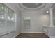 Bright living room with wood floors, decorative ceiling, two large windows and decorative pillars at 19109 Beckett Dr, Odessa, FL 33556
