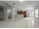 Open-concept living space with tile flooring seamlessly connects to kitchen and dining areas, great for entertaining at 19109 Beckett Dr, Odessa, FL 33556