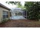 Screened in pool area with clean pool, patio and door leading to the backyard at 19109 Beckett Dr, Odessa, FL 33556