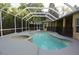 Screened-in pool with a jacuzzi next to the pool and a fence for safety at 19109 Beckett Dr, Odessa, FL 33556