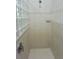 Tiled shower with glass block window and shower head at 19109 Beckett Dr, Odessa, FL 33556