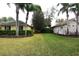 Spacious yard area between homes with lush lawn, mature trees, and manicured landscaping at 19109 Beckett Dr, Odessa, FL 33556