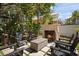 Charming backyard featuring an outdoor fireplace and comfortable seating area at 200 Grand Blvd, Tarpon Springs, FL 34689