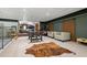 Finished basement area with decorative ceiling, carpet, wet bar, ample seating, and sliding barn doors at 200 Grand Blvd, Tarpon Springs, FL 34689