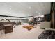 Finished basement featuring a decorative ceiling, carpet, multiple seating areas, and wet bar at 200 Grand Blvd, Tarpon Springs, FL 34689