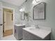 Bright bathroom featuring double sinks, decorative fixtures, and neutral tones, creating a serene and modern space at 200 Grand Blvd, Tarpon Springs, FL 34689