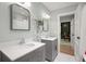 Bright bathroom featuring double sinks, decorative fixtures, and neutral tones, creating a serene and modern space at 200 Grand Blvd, Tarpon Springs, FL 34689