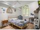 Bedroom features a window, neutral walls, and wood flooring at 200 Grand Blvd, Tarpon Springs, FL 34689